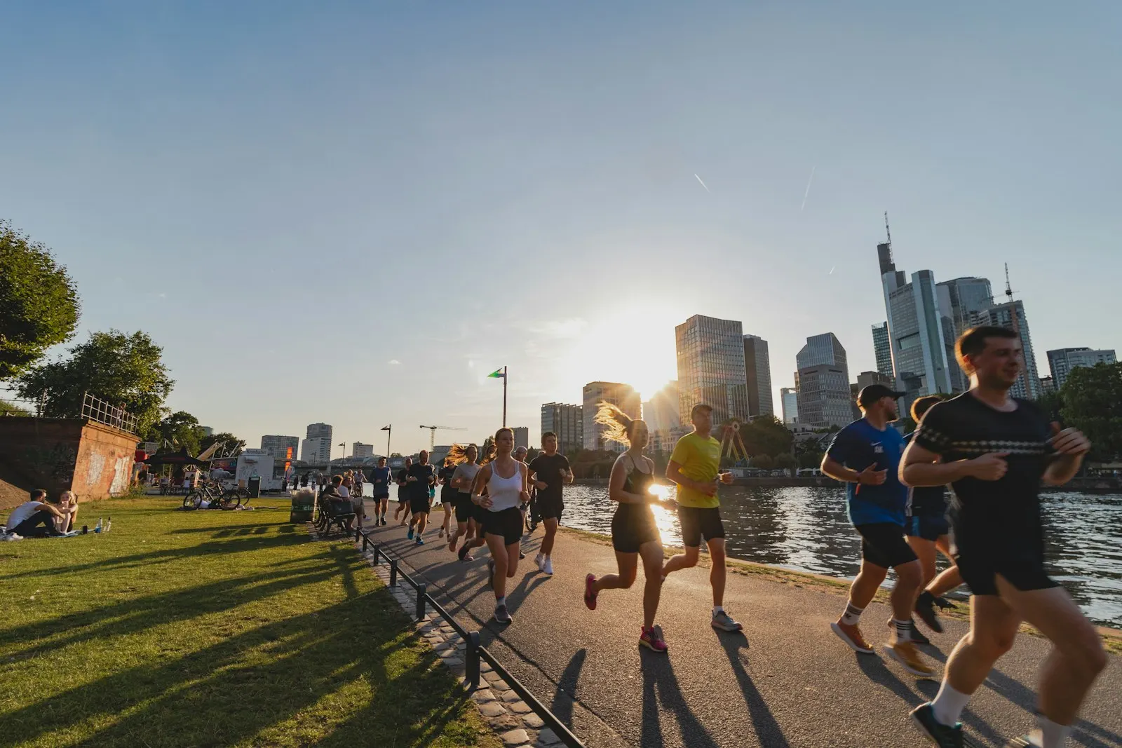 A running crew along a river at sunset
